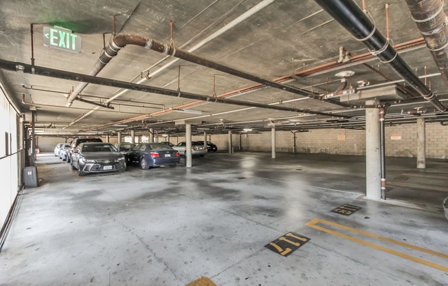 an empty parking garage with cars parked in it