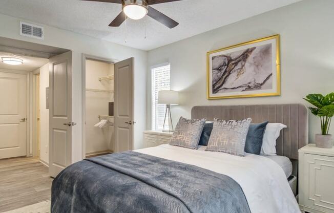 a bedroom with a large bed and a ceiling fan