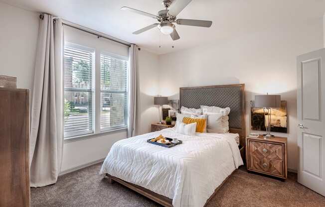 a bedroom with a large bed and a ceiling fan