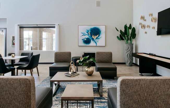 Comfortable clubhouse with seating, TV, and  shuffle board.