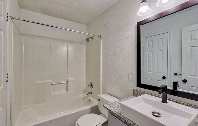 a bathroom with a sink toilet and bathtub