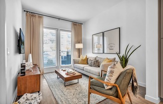 A living room with seating and a tv