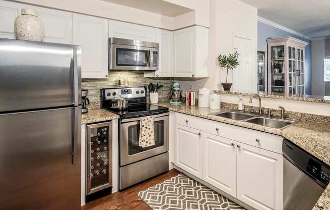 Modern kitchen with stainless appliances and granite counters