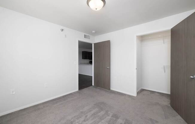 A room with a carpeted floor and a ceiling light.