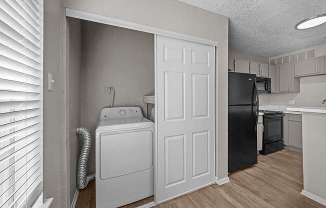 A laundry room with a washer and dryer in it.