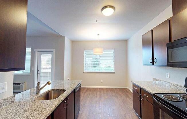 an empty kitchen with a sink and a stove