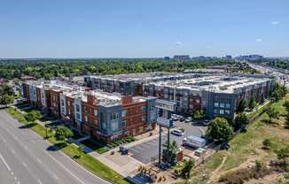 an aerial view of an apartment complex with a city in the background