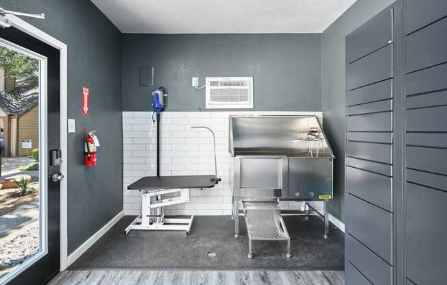 a kitchenette with a grill and a table and chairs