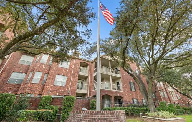 A flag pole with American flag in front of The Belmont