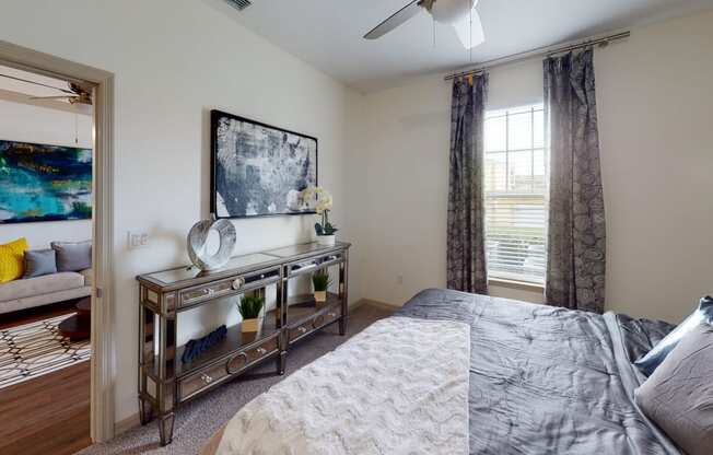 a bedroom with a large bed and a ceiling fan