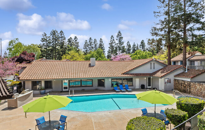 Clubhouse with a swimming pool in front of it