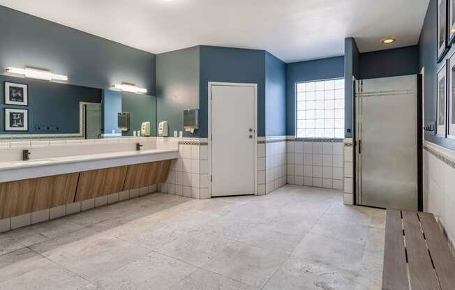 a large bathroom with a tub and a sink and a door at Mirasol Apartments, Las Vegas