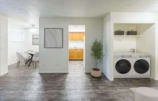A modern laundry room with a washer and dryer stacked on top of each other.