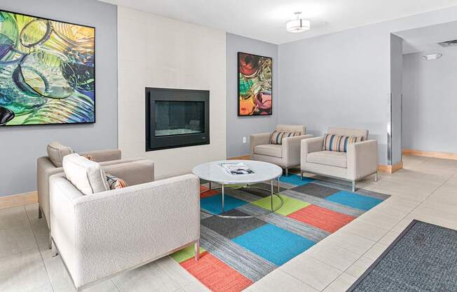 A living room with a white couch, a coffee table, and a painting on the wall.