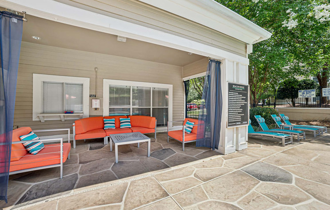 A patio with a table and chairs is shown at Beacon Ridge Apartments, PRG Real Estate Management, Greenville, 29615