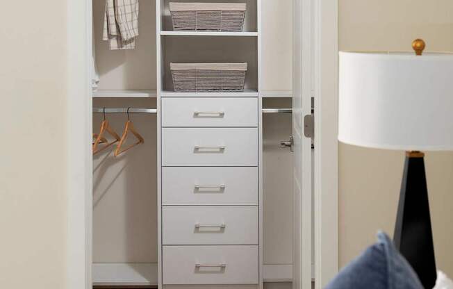 A white wardrobe with a white bed in front of it. at Palma, Florida, 33166
