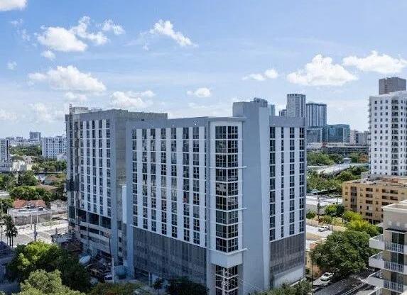 a tall building with a city in the background