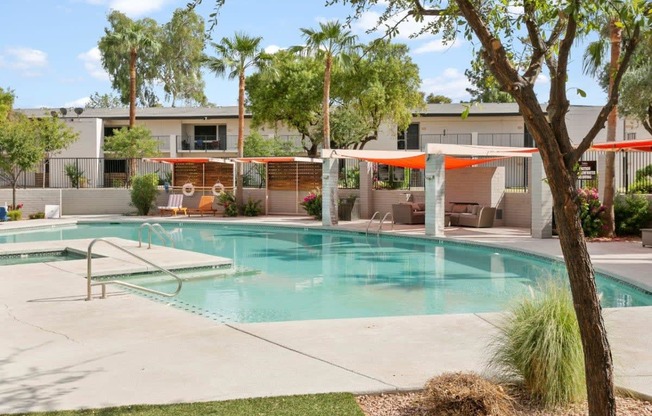 Tempe, AZ Apartments – Sentry Tempe – a swimming pool with trees and a building in the background