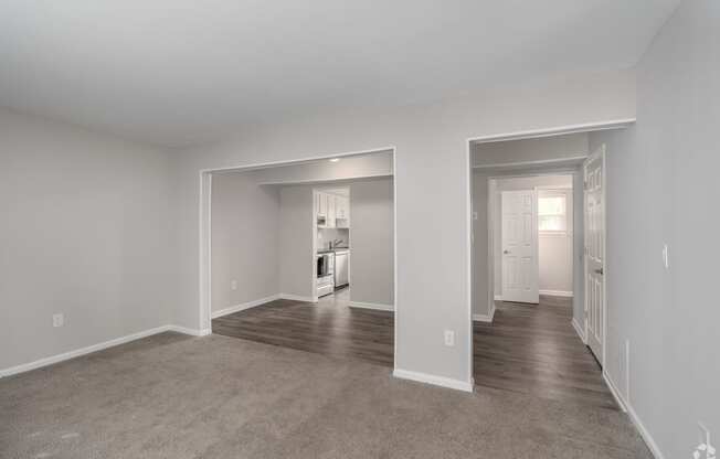 the living room and dining room of a new home with carpet and white walls