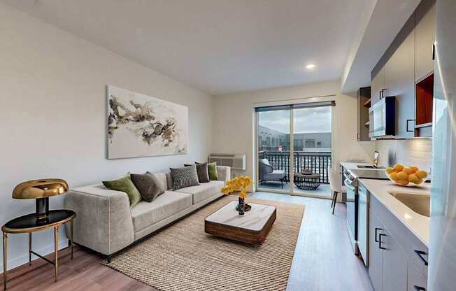 A modern living room with a grey couch and a coffee table.
