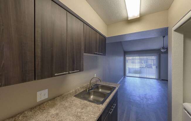 a kitchen with a sink and some wooden cabinets