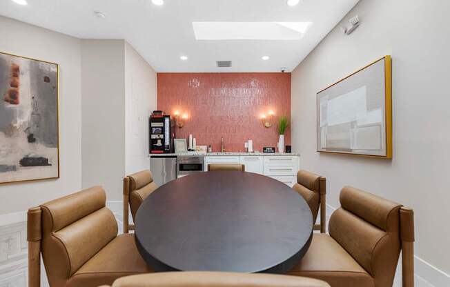 A conference room with a table surrounded by chairs.