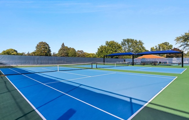 A tennis court with a blue surface and white lines.