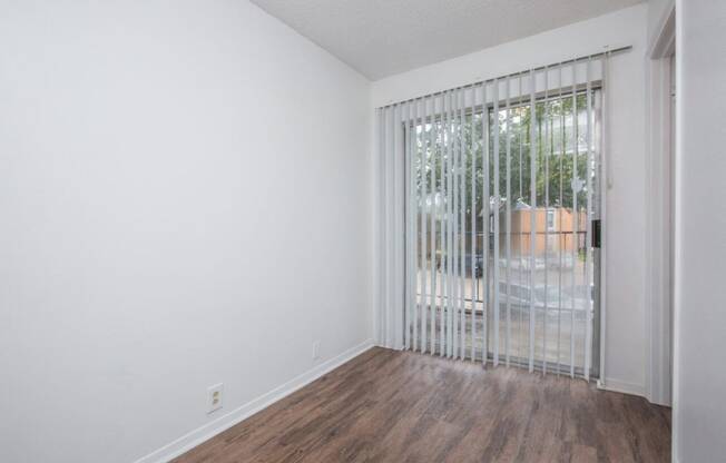 the living room has a large window and wood flooring