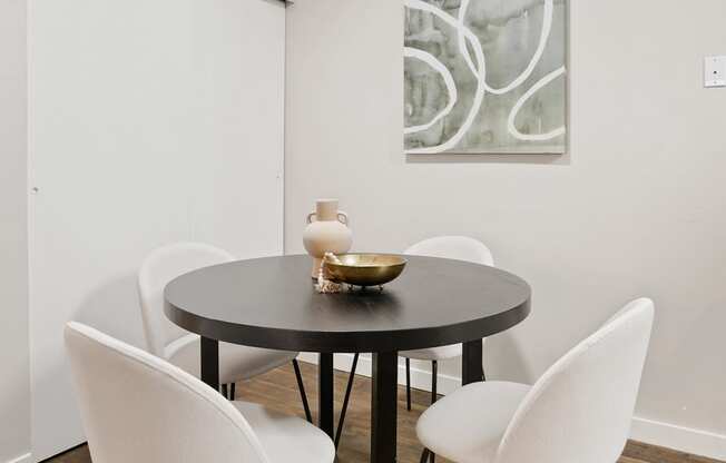The Grove Apartments Dining Area 4 white chairs and round table