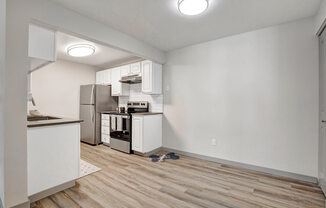 a kitchen with a stove top oven next to a refrigerator