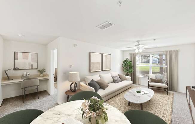 a living room with a white couch and a table with a vase of flowers on it