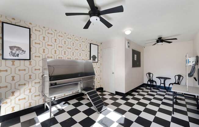A black and white checkered floor in a room with a fan.