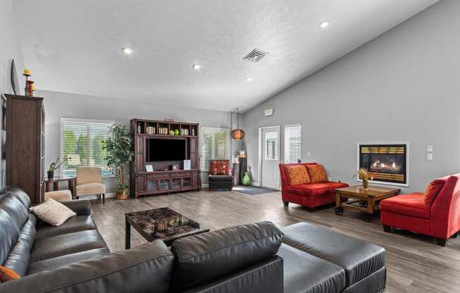 the living room has a fireplace and leather couches