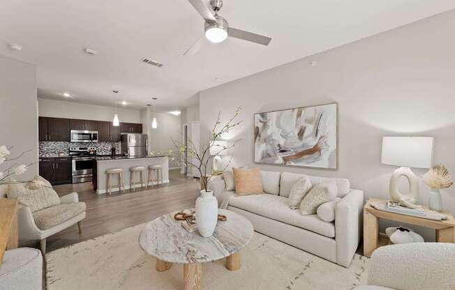 A modern living room with a white couch and a coffee table.