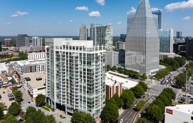 an aerial view of a city with tall buildings and trees