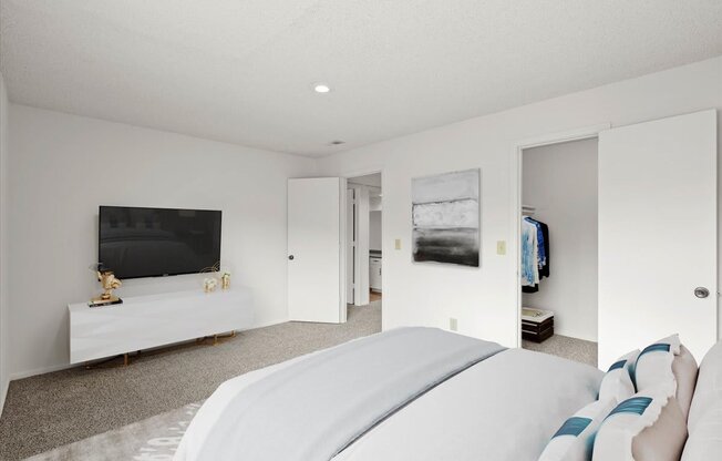 a bedroom with a large bed and a flat screen tv