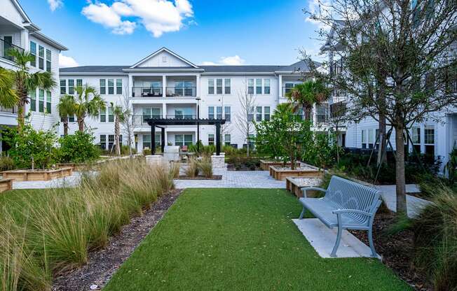 A white building with a green lawn in front.