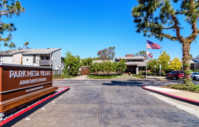 A sign for Park Mesa Villas Apartment Homes is in front of a building.