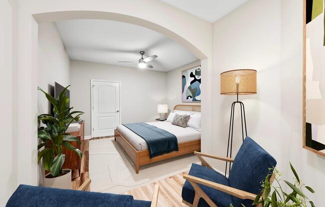 Bedroom suite with an arched entry, added sitting area, and spacious layout that creates flexibility for relaxation, reading, or working from home.