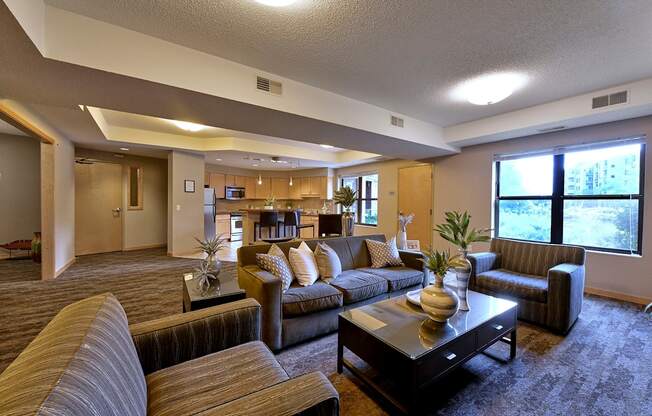 A living room with brown couches, chairs and a coffee table.
