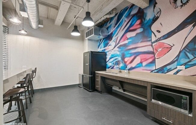 a kitchen with a counter and a mural on the wall