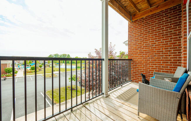 a balcony with a brick wall and a wooden deck