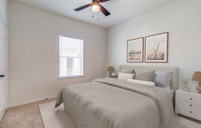 an expansive bedroom with a large bed and a ceiling fan