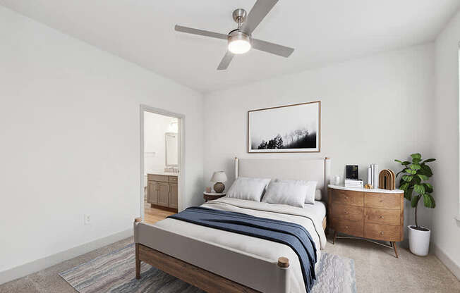 Model Bedroom with Carpet and attached Bathroom at Alta 3Eighty Apartments located in Aubrey, TX.