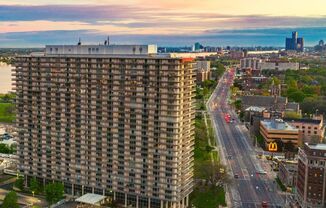 View from The Jefferson. The sun is setting in the background. The view shows Jefferson Ave in Detroit.