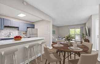 an open kitchen and dining area with a dining table and chairs