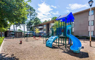 On-site playground with slides and mulch ground at this Atlanta apartment community.