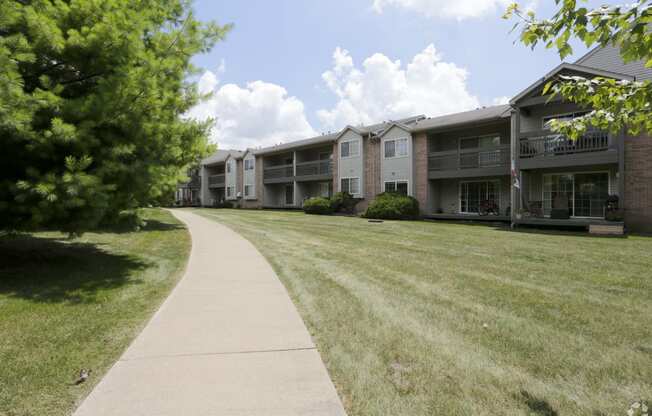 the view of an apartment building from a sidewalk