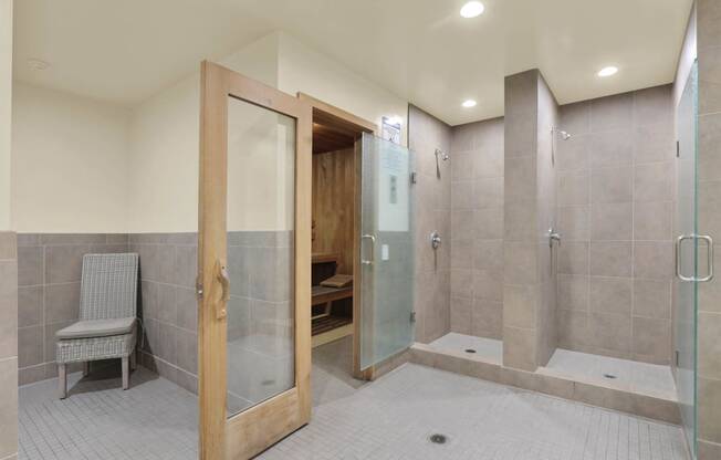 a large bathroom with a shower and a chair at Willow Tree Apartments, Torrance