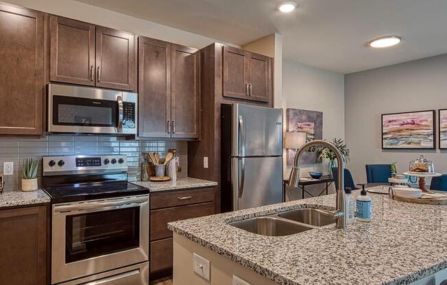 a kitchen with stainless steel appliances and a granite counter top  at Sapphire at Centerpointe, Virginia, 23114